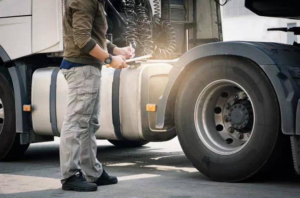 truck driver inspecting truck